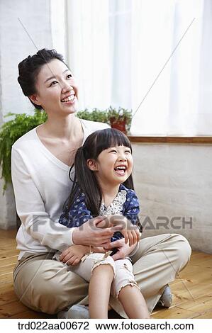 daughter sitting on mother's lap smiling View Large Photo Image Stock Image - daughter sitting on mother's lap smiling. Fotosearch