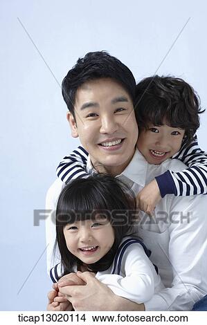 Picture - father and kids hugging. Fotosearch
