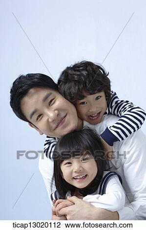 Stock Image - father and kids hugging. Fotosearch