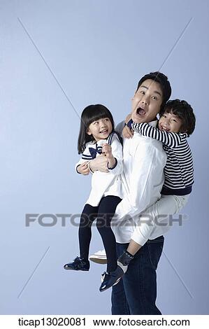 Stock Image - father carrying his kids. Fotosearch