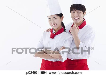 female and male cook in red apron looking happy View Large Photo Image Picture - female and male cook in red apron looking happy. Fotosearch