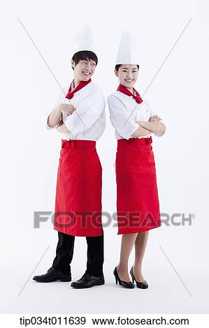 Stock Photo - female and male cook in red apron posing. Fotosearch
