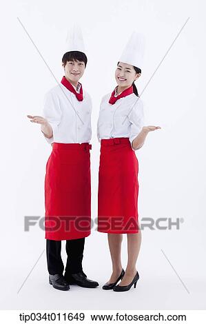 female and male cook in red apron posing View Large Photo Image Stock Photo - female and male cook in red apron posing. Fotosearch