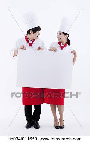 female and male cook in red apron holding empty board View Large Photo Image Stock Photo - female and male cook in red apron holding empty board. Fotosearch
