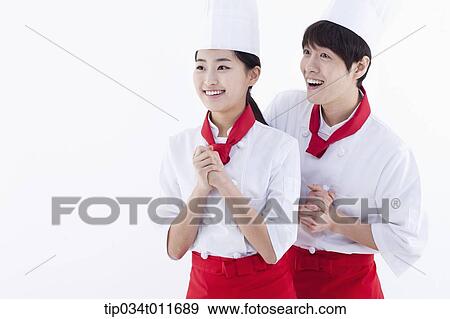 female and male cook in red apron looking happy View Large Photo Image Stock Photo - female and male cook in red apron looking happy. Fotosearch