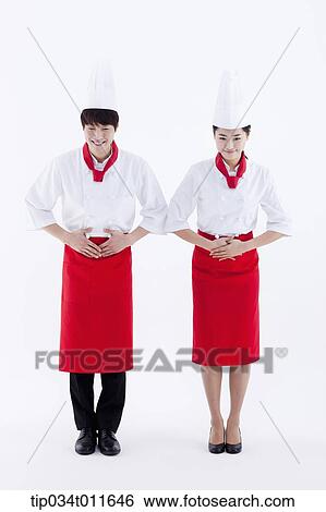 Stock Photograph - female and male cook in red apron bowing politely. Fotosearch