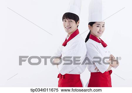female and male cook in red apron posing while standing back to back View Large Photo Image Stock Photography - female and male cook in red apron posing while standing back to back. Fotosearch