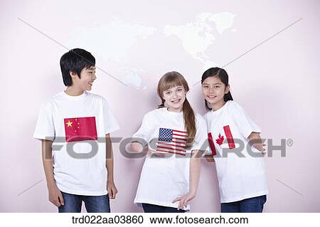 Stock Image - kids with Chinese, American and Canadian flags on their t-shirts. Fotosearch