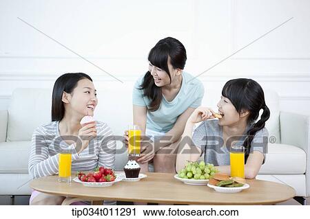 ladies chatting while having desserts View Large Photo Image Stock Image - ladies chatting while having desserts . Fotosearch