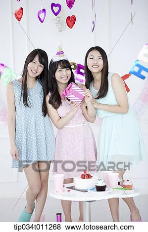 Stock Photo - ladies posing in the birthday party. Fotosearch