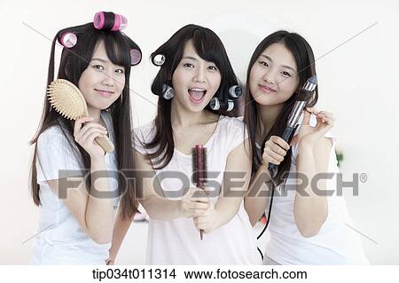 Picture - ladies posing with hair equipment. Fotosearch