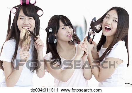 Stock Image - ladies posing with hair equipment. Fotosearch
