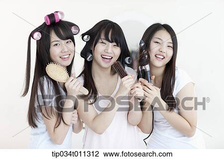 ladies posing with hair equipment View Large Photo Image Stock Image - ladies posing with hair equipment. Fotosearch