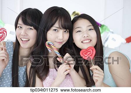 ladies posing with lollipops in the party View Large Photo Image Stock Photography - ladies posing with lollipops in the party. Fotosearch