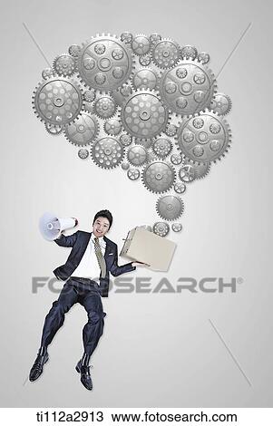 Stock Image - man holding a box with gears flying out. Fotosearch
