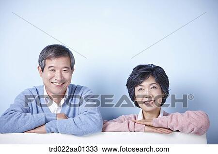 middle aged couple leaning on blank board View Large Photo Image Stock Image - middle aged couple leaning on blank board. Fotosearch