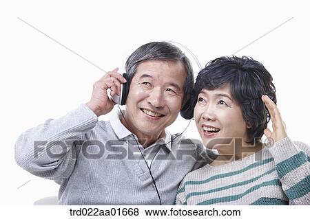 middle aged couple sharing music on a couch View Large Photo Image Stock Photo - middle aged couple sharing music on a couch. Fotosearch
