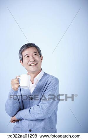 middle aged man drinking cup of coffee View Large Photo Image Stock Photo - middle aged man drinking cup of coffee. Fotosearch