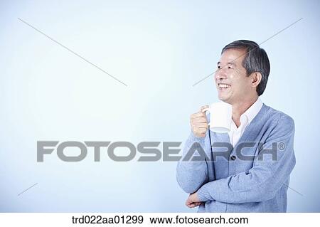 middle aged man drinking cup of coffee View Large Photo Image Stock Photo - middle aged man drinking cup of coffee. Fotosearch
