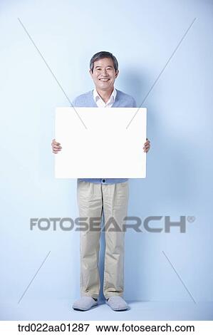middle aged man holding blank board View Large Photo Image Stock Photo - middle aged man holding blank board. Fotosearch