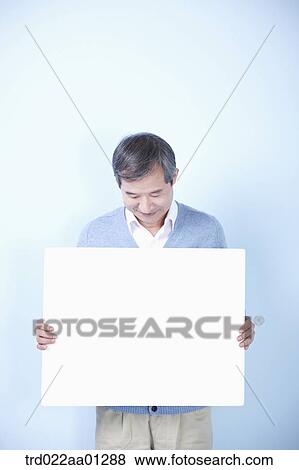 middle aged man holding blank board View Large Photo Image Stock Photo - middle aged man holding blank board. Fotosearch