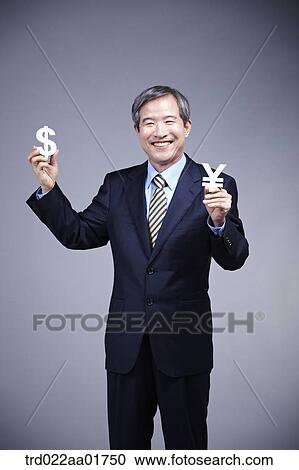 middle aged man in a business suit holding currency blocks View Large Photo Image Stock Image - middle aged man in a business suit holding currency blocks. Fotosearch