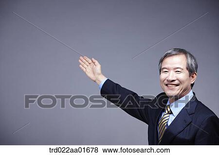 middle aged man in a business suit presenting View Large Photo Image Stock Photo - middle aged man in a business suit presenting. Fotosearch