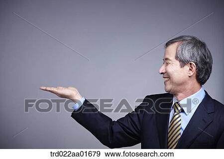 middle aged man in a business suit presenting View Large Photo Image Stock Photo - middle aged man in a business suit presenting. Fotosearch