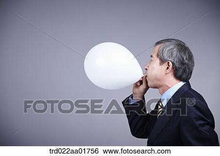 middle aged man in a business suit blowing balloon View Large Photo Image Stock Photograph - middle aged man in a business suit blowing balloon. Fotosearch