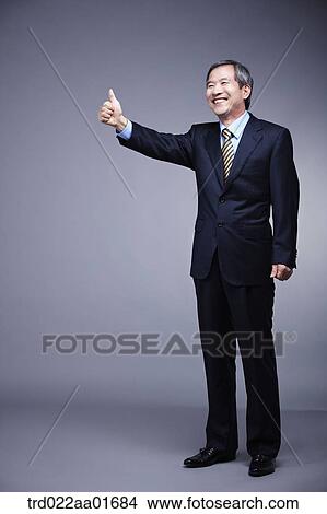 middle aged man in a business suit with thumb up View Large Photo Image Picture - middle aged man in a business suit with thumb up. Fotosearch