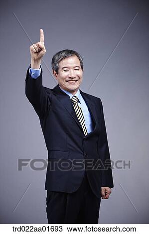 middle aged man in a business suit with one sign View Large Photo Image Stock Image - middle aged man in a business suit with one sign. Fotosearch