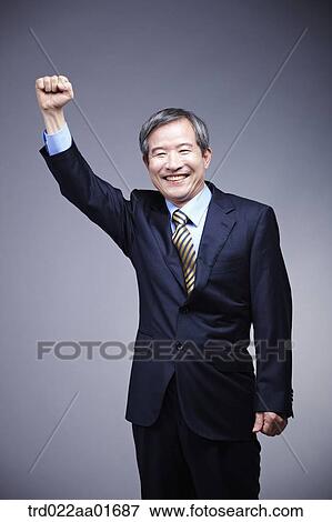 middle aged man in a business suit with cheering pose View Large Photo Image Stock Photo - middle aged man in a business suit with cheering pose. Fotosearch