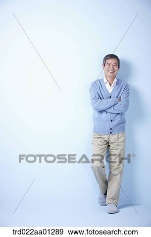 middle aged man leaning on blue background View Large Photo Image Stock Photo - middle aged man leaning on blue background. Fotosearch