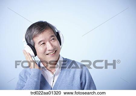 middle aged man listening to music View Large Photo Image Stock Image - middle aged man listening to music. Fotosearch