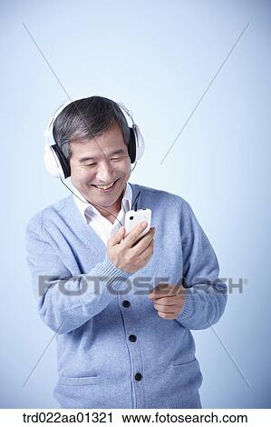 middle aged man listening to music View Large Photo Image Stock Image - middle aged man listening to music. Fotosearch