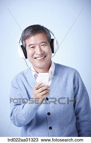 middle aged man listening to music View Large Photo Image Stock Image - middle aged man listening to music. Fotosearch