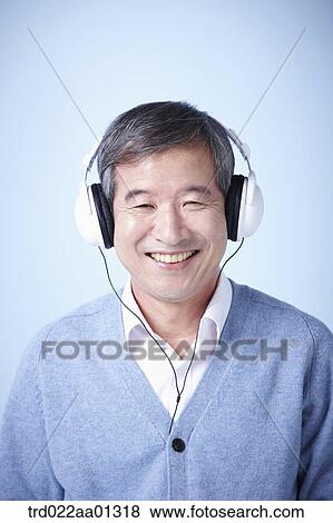 Stock Photo - middle aged man listening to music. Fotosearch