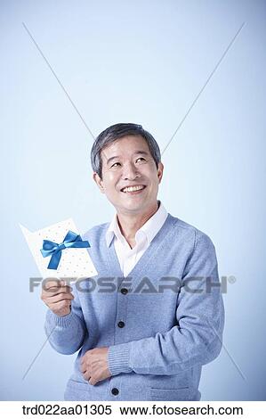 middle aged man reading a card View Large Photo Image Stock Photography - middle aged man reading a card. Fotosearch