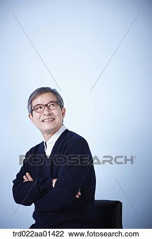 middle aged man sitting on a chair View Large Photo Image Stock Image - middle aged man sitting on a chair. Fotosearch