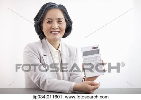 middle aged woman in business suit using calculator View Large Photo Image Stock Image - middle aged woman in business suit using calculator. Fotosearch