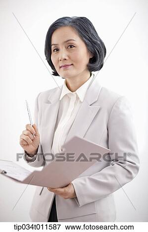 Stock Photo - middle aged woman in business suit holding a folder. Fotosearch