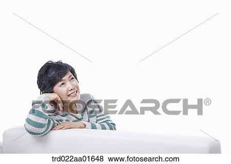 middle aged woman leaning on a couch View Large Photo Image Stock Photo - middle aged woman leaning on a couch. Fotosearch