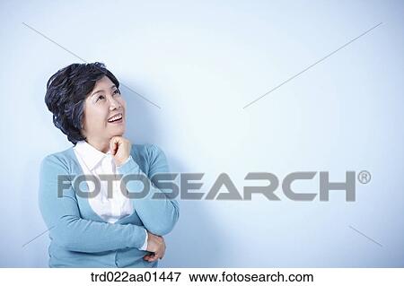 middle aged woman standing on blue background View Large Photo Image Stock Photo - middle aged woman standing on blue background. Fotosearch