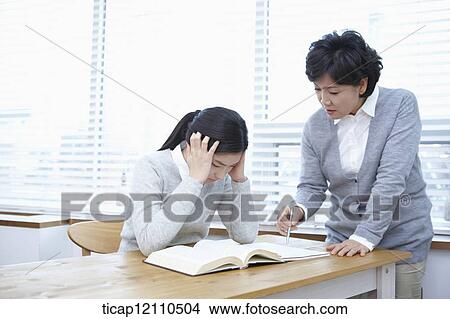 middle aged woman teaching a student View Large Photo Image Picture - middle aged woman teaching a student . Fotosearch
