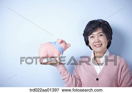 middle aged woman with a piggy bank View Large Photo Image Stock Photo - middle aged woman with a piggy bank. Fotosearch