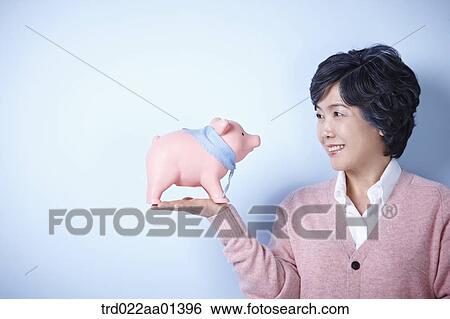 middle aged woman with a piggy bank View Large Photo Image Stock Photograph - middle aged woman with a piggy bank. Fotosearch
