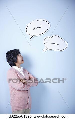 Stock Photography - middle aged woman with two speech bubbles. Fotosearch