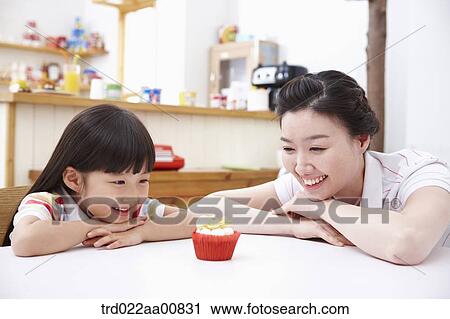 mother and daughter at table with cookies View Large Photo Image Stock Image - mother and daughter at table with cookies. Fotosearch
