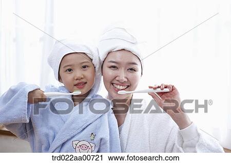 mother and daughter brushing teeth together View Large Photo Image Stock Image - mother and daughter brushing teeth together. Fotosearch