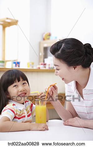 mother and daughter drinking juice together View Large Photo Image Stock Photo - mother and daughter drinking juice together. Fotosearch